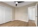 This bedroom features wood floors, ceiling fan, and closet space at 7839 E Osage Ave, Mesa, AZ 85212