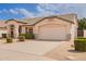 Single-story home featuring a spacious driveway and a two-car garage at 7839 E Osage Ave, Mesa, AZ 85212
