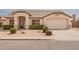 Attractive single-Gathering house showcasing a two-car garage, manicured bushes, and a welcoming covered entrance at 7839 E Osage Ave, Mesa, AZ 85212