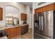Charming kitchen with stainless steel refrigerator and wooden cabinets at 7839 E Osage Ave, Mesa, AZ 85212