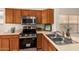 Well-lit kitchen features stainless steel appliances, wood cabinetry, and a double-basin sink at 7839 E Osage Ave, Mesa, AZ 85212