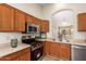 Cozy kitchen showcasing wooden cabinetry, stainless steel appliances, and plenty of counter space at 7839 E Osage Ave, Mesa, AZ 85212