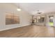 Spacious living area with plenty of natural light, wood floors, and ceiling fan at 7839 E Osage Ave, Mesa, AZ 85212
