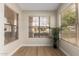 Sun-filled room with neutral walls and wood floors, with three large windows at 7839 E Osage Ave, Mesa, AZ 85212