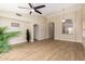 Open-concept living room with ample space, wood floors, and neutral paint at 7839 E Osage Ave, Mesa, AZ 85212