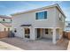 View of the home's backyard and exterior featuring a patio and a sliding glass door with canopy at 8240 E Quintuplet Ave, Mesa, AZ 85212