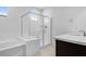 Modern bathroom featuring a glass shower, a bathtub, and white tile flooring at 8240 E Quintuplet Ave, Mesa, AZ 85212