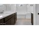 Bright bathroom featuring double sink, bathtub, glass shower and tile flooring at 8240 E Quintuplet Ave, Mesa, AZ 85212