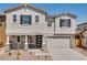 Charming two-story home with a well-maintained yard, a two-car garage, and a welcoming front porch at 8240 E Quintuplet Ave, Mesa, AZ 85212