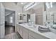 Bathroom with a dual sink vanity, ample counter space, and a large mirror at 8245 E Bell Rd # 133, Scottsdale, AZ 85260