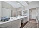 Elegant bathroom featuring dual sinks, a large mirror, and abundant counter space at 8245 E Bell Rd # 133, Scottsdale, AZ 85260