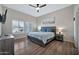 Comfortable bedroom with stylish furnishings, including a bed with nightstands and a ceiling fan at 8245 E Bell Rd # 133, Scottsdale, AZ 85260