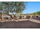 Well-maintained front yard featuring desert landscaping and a mature tree, enhancing curb appeal at 8245 E Bell Rd # 133, Scottsdale, AZ 85260