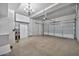 Spacious garage with overhead lighting and ample storage cabinets at 8245 E Bell Rd # 133, Scottsdale, AZ 85260