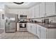 Kitchen featuring stainless steel appliances, granite countertops, and white cabinets at 8245 E Bell Rd # 133, Scottsdale, AZ 85260