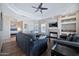 Cozy living room featuring a fireplace, ceiling fan, and comfortable seating arrangement at 8245 E Bell Rd # 133, Scottsdale, AZ 85260