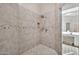 Modern tiled shower stall with a mosaic accent and a glass enclosure at 8245 E Bell Rd # 133, Scottsdale, AZ 85260
