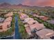 Picturesque aerial view of a residential area featuring desert landscaping with mountain backdrop at 9439 E Trailside Vw, Scottsdale, AZ 85255