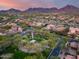 Scenic aerial view capturing community green space, native landscape and desert mountain views at 9439 E Trailside Vw, Scottsdale, AZ 85255