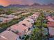 Aerial view of neighborhood showcasing pool, yards, and desert landscaping with mountain views at 9439 E Trailside Vw, Scottsdale, AZ 85255