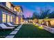 Large backyard featuring a barbecue, lounge chairs, fire pit, and well-maintained landscaping at 9439 E Trailside Vw, Scottsdale, AZ 85255