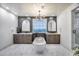 Luxurious bathroom featuring a soaking tub, dual vanities, modern light fixture and oversized tile flooring at 9439 E Trailside Vw, Scottsdale, AZ 85255