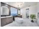 Beautiful bathroom with dual sink vanities, soaking tub, modern tile, and sleek chandelier lighting at 9439 E Trailside Vw, Scottsdale, AZ 85255