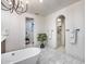 Large bathroom featuring modern soaking tub, walk in shower, unique hexagon tile and ample lighting at 9439 E Trailside Vw, Scottsdale, AZ 85255