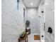 Modern bathroom features marble walls, dual windows, walk-in shower, and tasteful decor at 9439 E Trailside Vw, Scottsdale, AZ 85255
