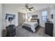 Cozy bedroom with a gray padded headboard, ceiling fan, exercise equipment and plentiful natural light at 9439 E Trailside Vw, Scottsdale, AZ 85255