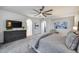 Comfortable bedroom with decorative furnishings, including ceiling fan, dresser, and plush carpeting at 9439 E Trailside Vw, Scottsdale, AZ 85255