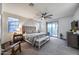 Spacious bedroom with large bed, ceiling fan, dresser and access to outdoor balcony at 9439 E Trailside Vw, Scottsdale, AZ 85255