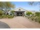 Inviting exterior view of the clubhouse, highlighting the entryway with a decorative wreath and desert landscaping at 9439 E Trailside Vw, Scottsdale, AZ 85255