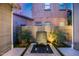Private courtyard featuring a stone water feature, lush greenery, and modern design at 9439 E Trailside Vw, Scottsdale, AZ 85255
