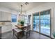 Bright dining area with a wooden table, modern lighting, and sliding doors to an outdoor patio at 9439 E Trailside Vw, Scottsdale, AZ 85255