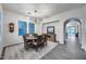 Dining room with wooden table, six chairs, modern chandelier, and access to the living room at 9439 E Trailside Vw, Scottsdale, AZ 85255