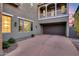 View of driveway leading to a three-car garage and an upper-story balcony at 9439 E Trailside Vw, Scottsdale, AZ 85255