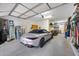 This spacious garage has storage and organization, and features a sleek silver convertible at 9439 E Trailside Vw, Scottsdale, AZ 85255