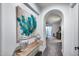 Inviting hallway with artful flower painting and decorative vases on a light wood table at 9439 E Trailside Vw, Scottsdale, AZ 85255