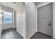 Bright hallway with modern lighting, tile floors, and a view of the front door at 9439 E Trailside Vw, Scottsdale, AZ 85255