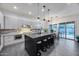 Modern kitchen features a large center island with seating, sleek cabinetry, and stainless steel appliances at 9439 E Trailside Vw, Scottsdale, AZ 85255