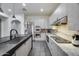Stylish kitchen featuring stainless steel appliances, gray cabinetry, and sleek black countertops at 9439 E Trailside Vw, Scottsdale, AZ 85255