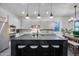 Sleek kitchen with stainless appliances, quartz countertops, and a central island with barstool seating at 9439 E Trailside Vw, Scottsdale, AZ 85255