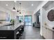 Modern kitchen with an island featuring seating and a large sink, open to living areas at 9439 E Trailside Vw, Scottsdale, AZ 85255