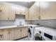 Bright laundry room featuring front loading washer and dryer, tile flooring, and ample storage at 9439 E Trailside Vw, Scottsdale, AZ 85255