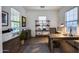 Well-lit home office with custom shelving, tile floors, and comfortable desk space at 9439 E Trailside Vw, Scottsdale, AZ 85255