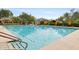 Bright, inviting community pool featuring lane lines, umbrellas and lounge chairs at 9439 E Trailside Vw, Scottsdale, AZ 85255