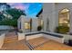 Spacious backyard patio area with built-in seating, desert landscaping, and charming architectural details at 9760 E San Salvador Dr, Scottsdale, AZ 85258