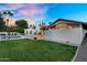 Lush backyard with a sparkling pool, well-manicured lawn, and elegant architectural features, creating a private oasis at 9760 E San Salvador Dr, Scottsdale, AZ 85258