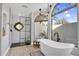 Bathroom with an elegant shower, standalone tub, and statement stained glass window at 9760 E San Salvador Dr, Scottsdale, AZ 85258